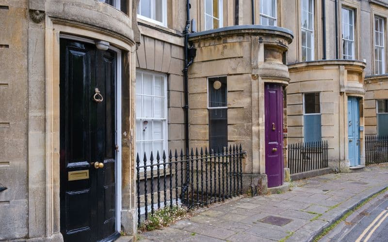 Row of colourful painted UPVC front doors on a British street