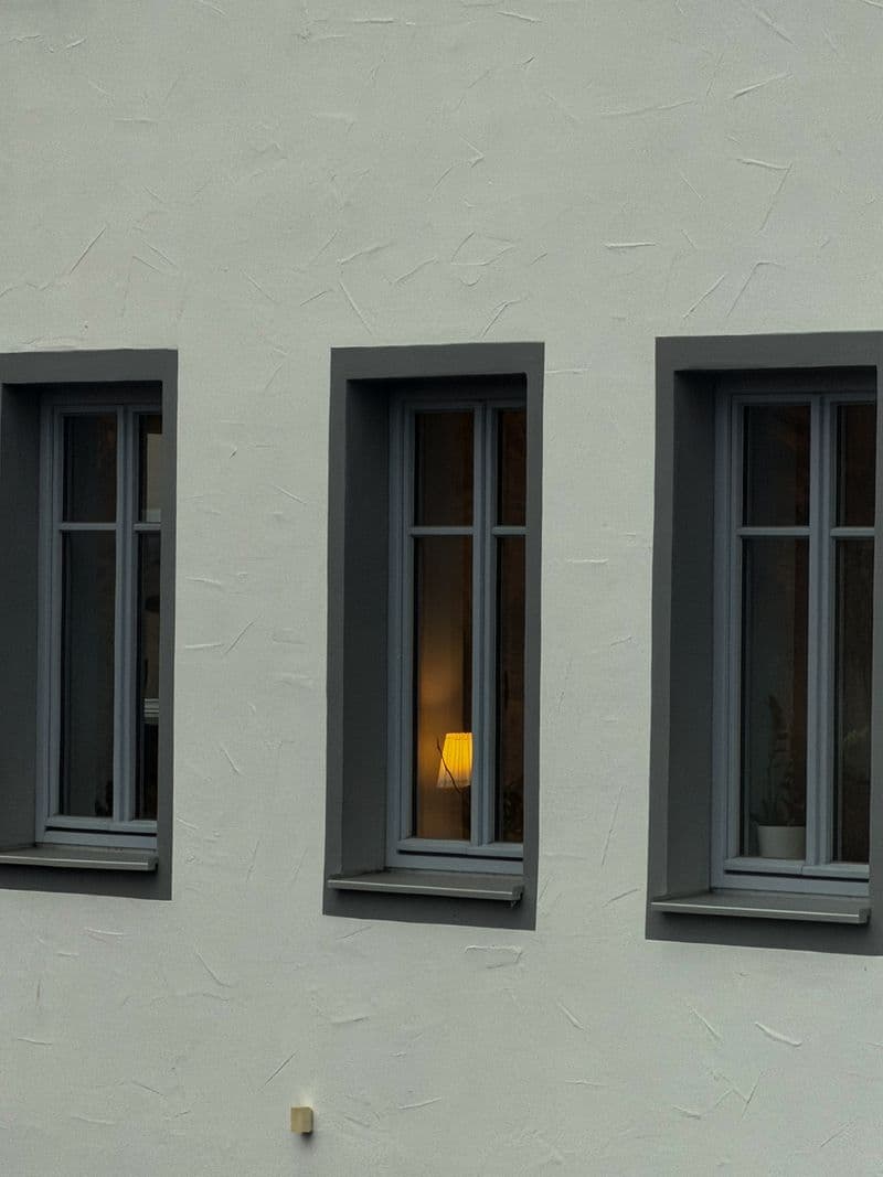 Modern grey UPVC window frames on a white rendered house exterior